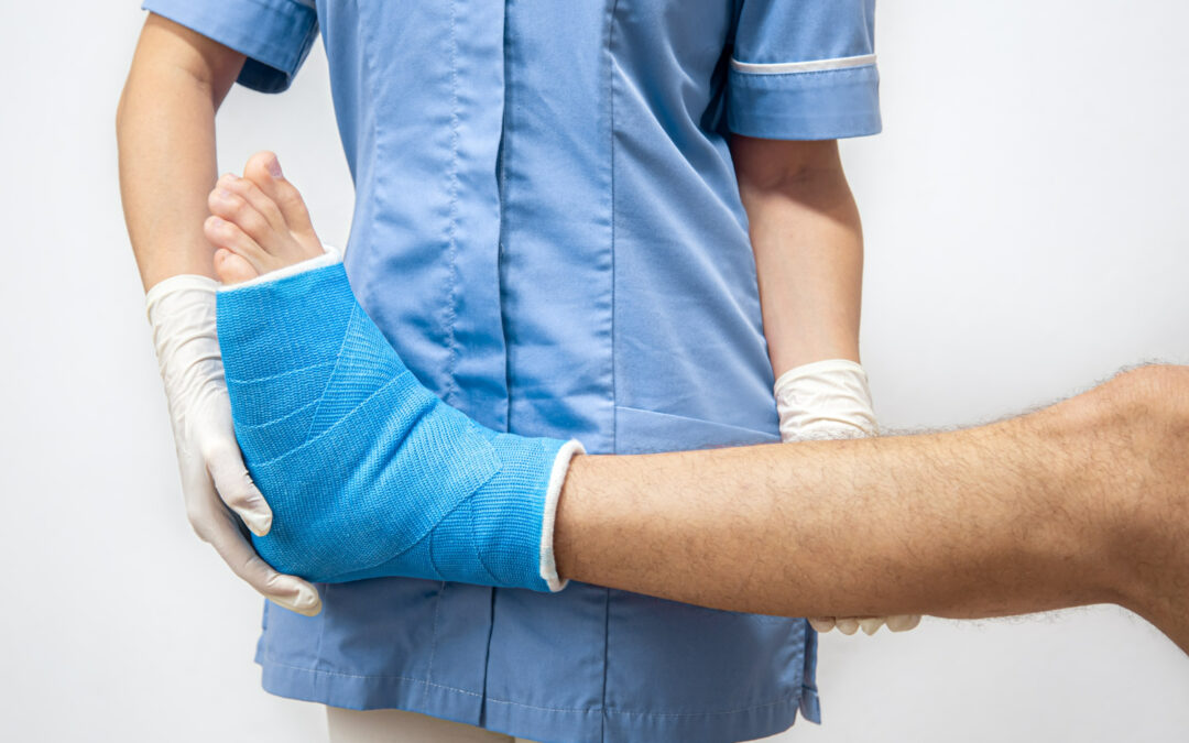 nurse checking a patient's sprained ankle - acute and chronic pain